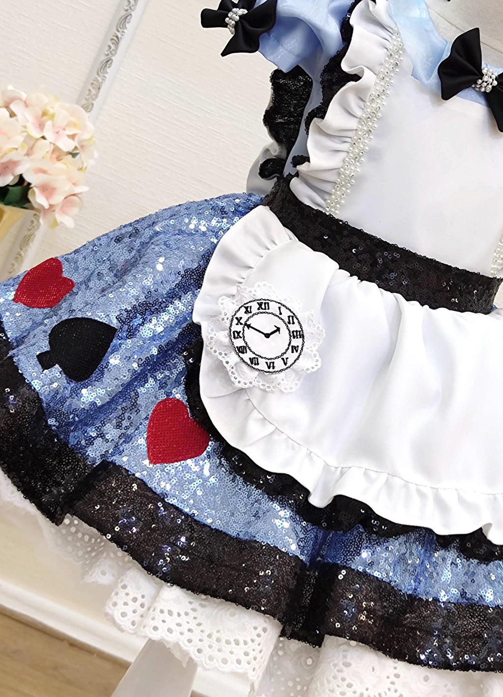 Pale blue bodice with white lace and black ribbon details on a handmade Alice costume style dress.